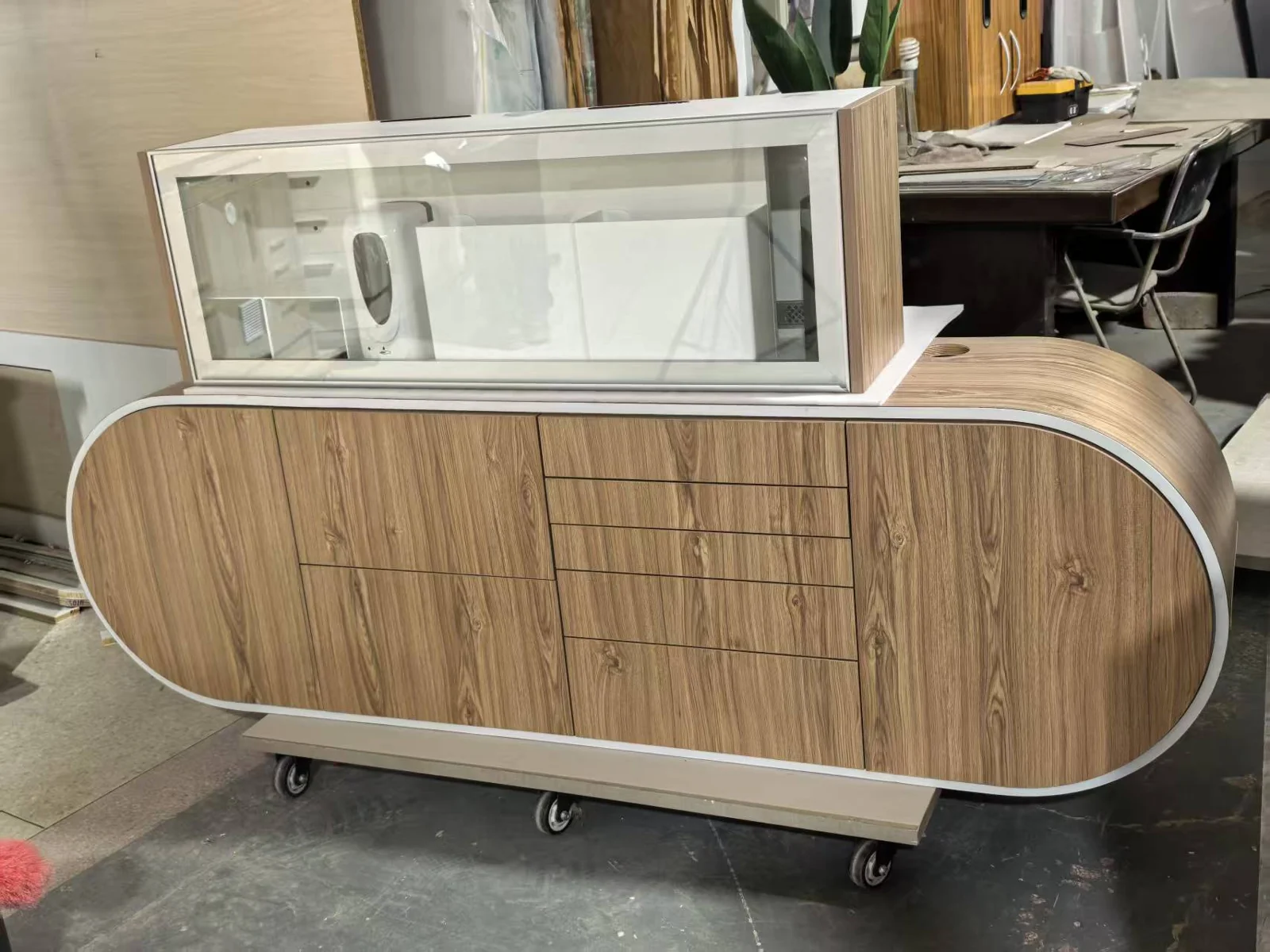 TJ-DC50 curved wood grain cabinet in a factory or showroom