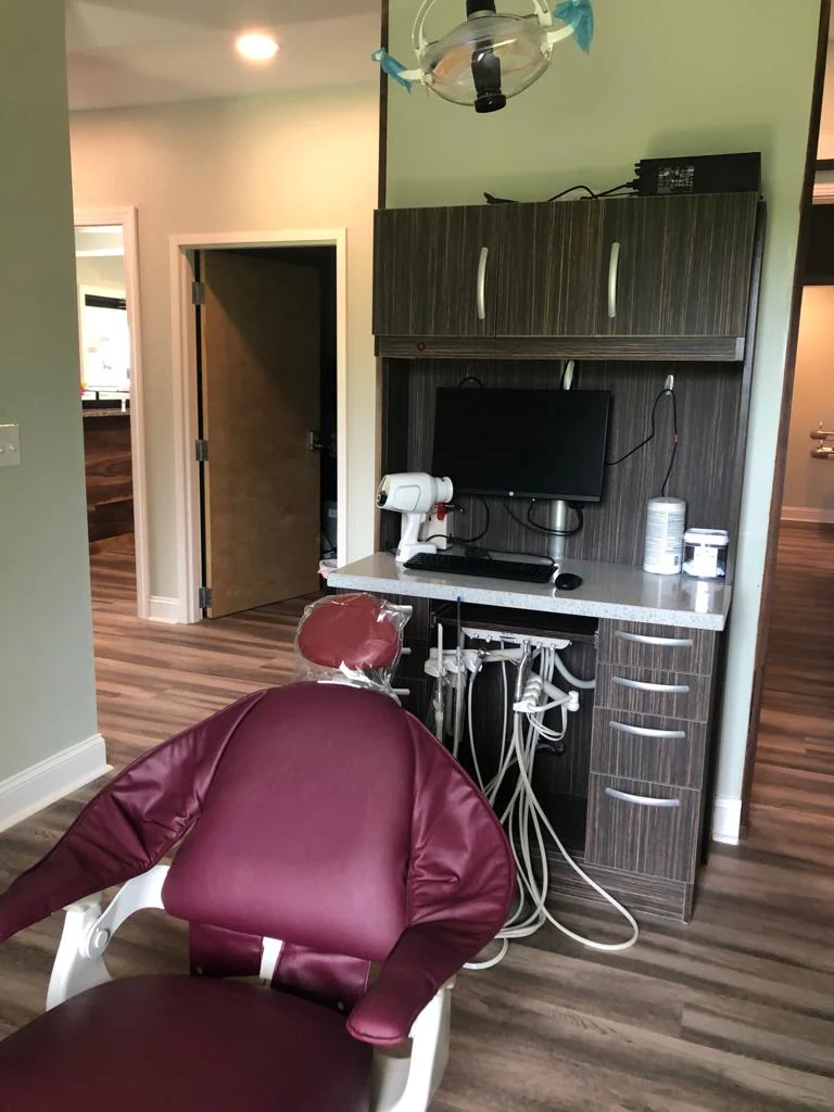 TJ-DC500 dark wood cabinet beside a dental chair